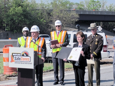 Deputy Transportation Secretary Harold M. Bartlett appears with law enforcement to stress that slowing down in work zones saves the lives of both workers and drivers.